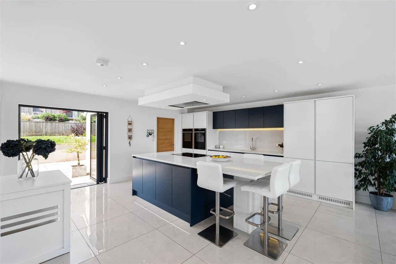 Open-plan living space with floor-to-ceiling glazing onto the countryside