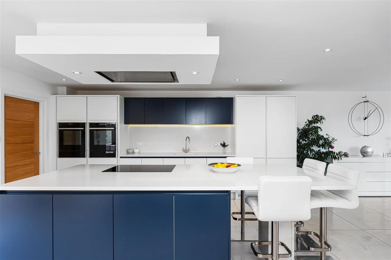 Designer kitchen with an oversized island and integrated appliances