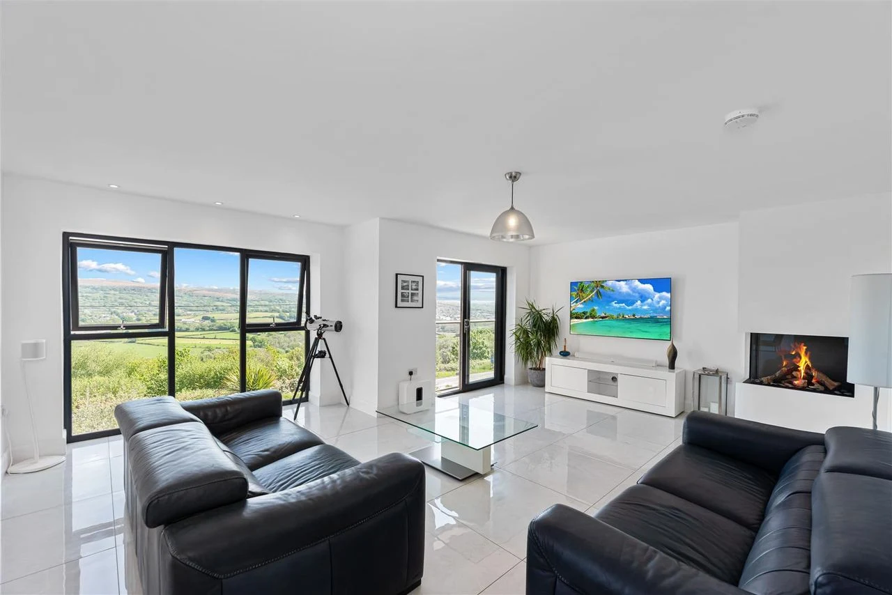 Living room with a contemporary fireplace and large windows